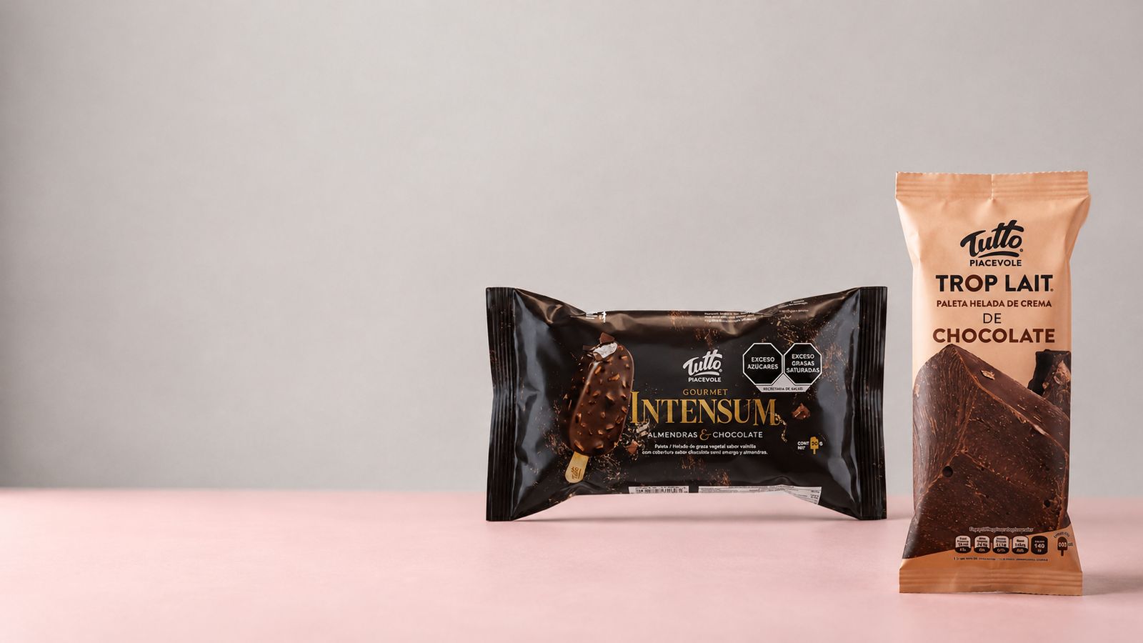 Empaques flexibles impresos de las barras de chocolate Tutto Intensum y Tutto Trop Lait sobre un fondo rosa claro